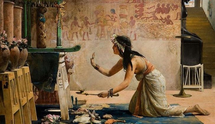 Ancient Egyptian woman worshipping cats.